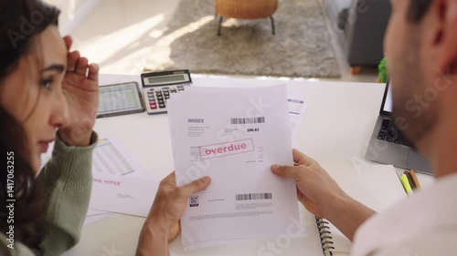 Couple facing overdue bills and financial pressure at home, stressed by inflation and economy recession