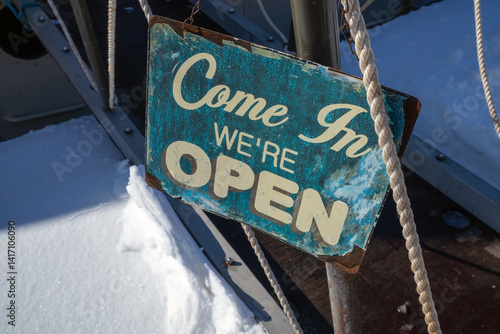 Come In We're Open Sign outdoors in sunlight