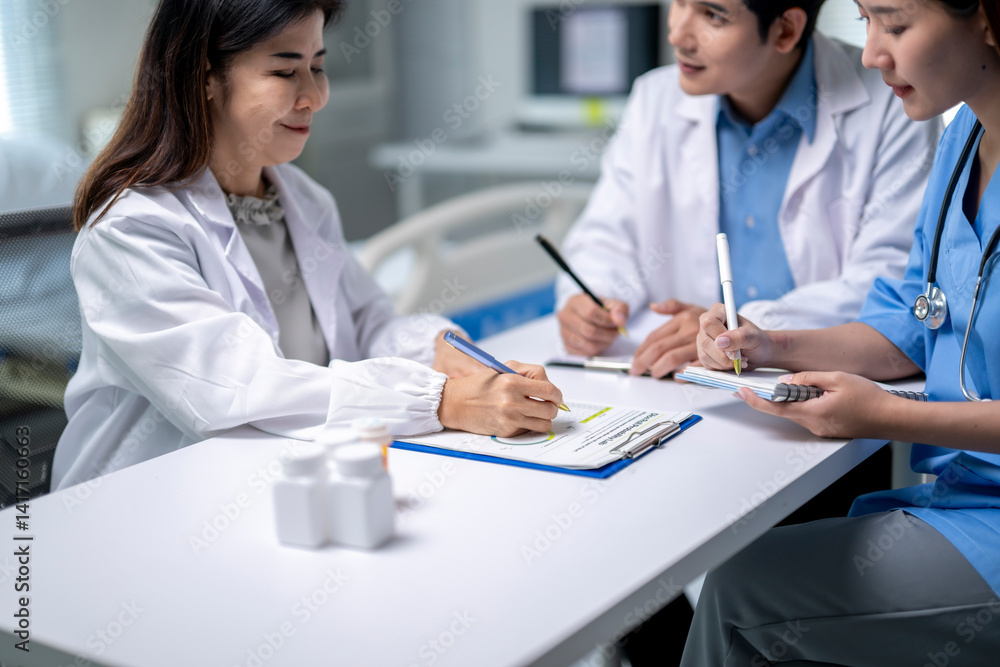 Three doctors are sitting at a table, writing on a clipboard Three doctors are sitting at a table, writing on a clipboard