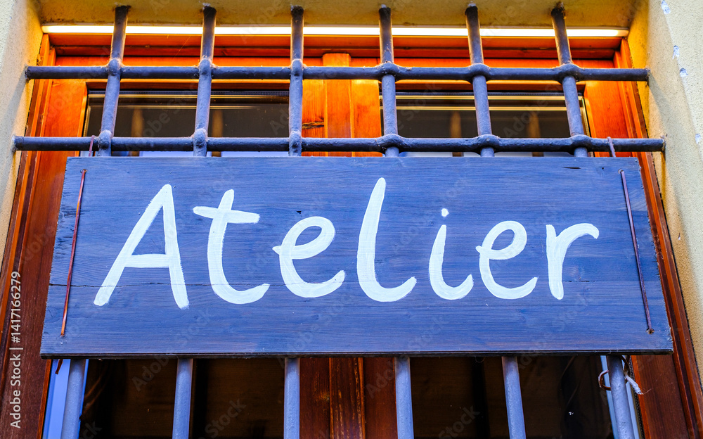 custom made wallpaper toronto digitalSign indicating an atelier located in a vibrant neighborhood, showcasing artistic craftsmanship and creative workspaces during daylight hours