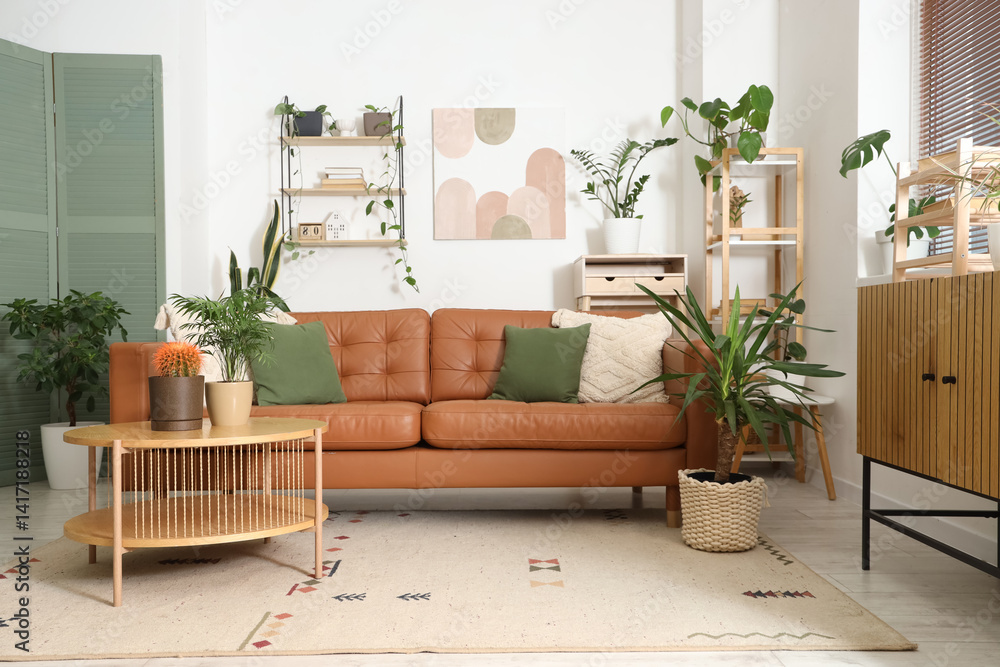 Interior of stylish living room with brown armchair, coffee table and houseplants