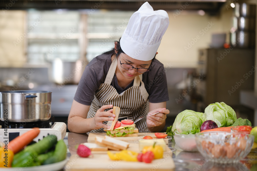 Focused chef carefully a gourmet sandwich in a professional kitchen with fresh ingredients in view Focused chef carefully a gourmet sandwich in a professional kitchen with fresh ingredients in view