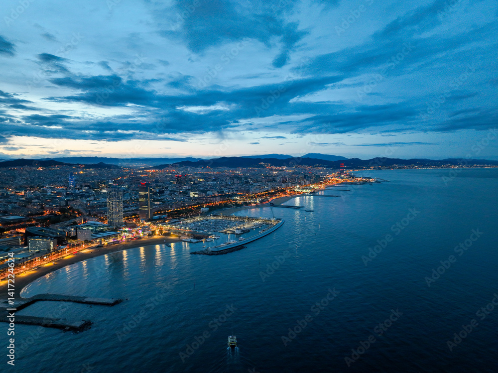 Aerial view of illuminated Barcelona beach and city skyline at blue hour Aerial view of illuminated Barcelona beach and city skyline at blue hour