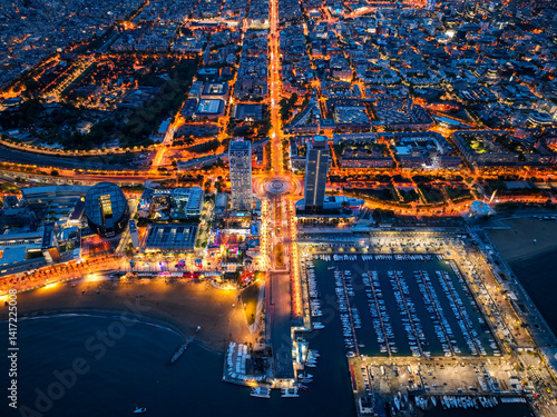 Photography Overhead night view of Port Olimpic marina and city lights along the beach