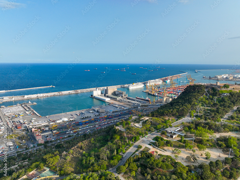 Fototapeta premium Aerial view of Barcelona city leading to the port and sea