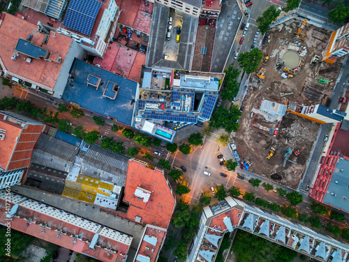 Photography Vertical aerial of Barcelona street grid with building site and solar roof