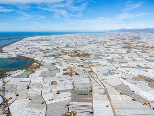 Aerial view of Mar de Plastico, Sea of ​​Plastic, in Almería. A vast expanse of land covered with plastic greenhouses for the production of fruits and vegetables, larger than Almería itself