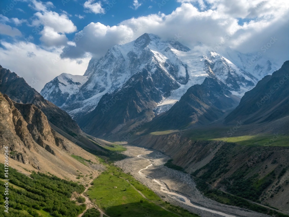 Fototapeta premium A majestic snow-capped mountain range with a winding river running through the valley below
