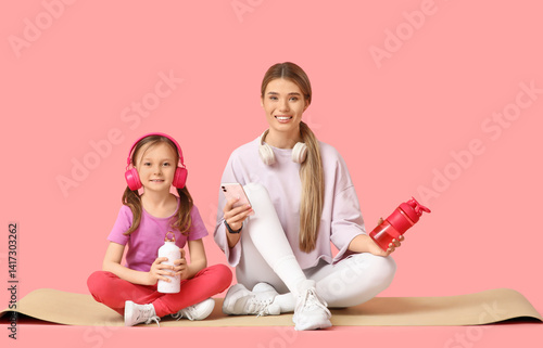 Sporty young mother and her...