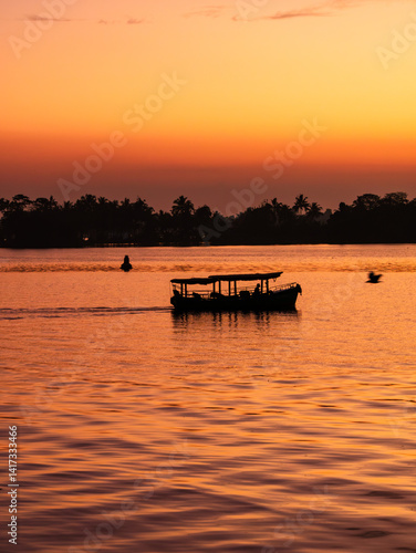 silhouette of boat in Alappuzha, highly visited tourist destination, during the sunset