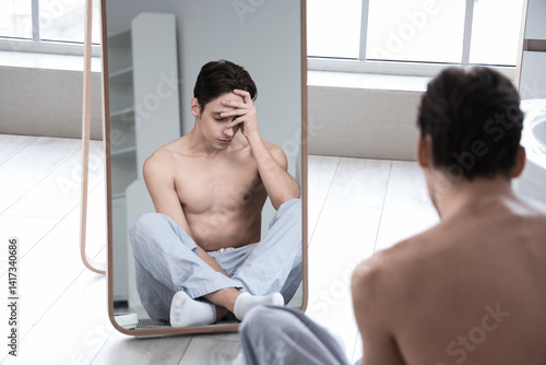 Young man with anorexia loo...