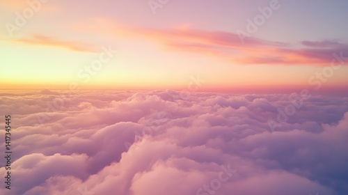 Flying above a dense layer of clouds at sunset reveals a spectacular view of the colorful sky painted in shades of orange, pink, and purple over the vast cloudscape.