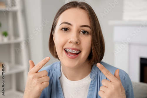 Young woman pointing at den...