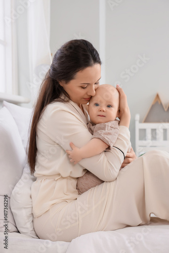 Happy mother hugging her li...