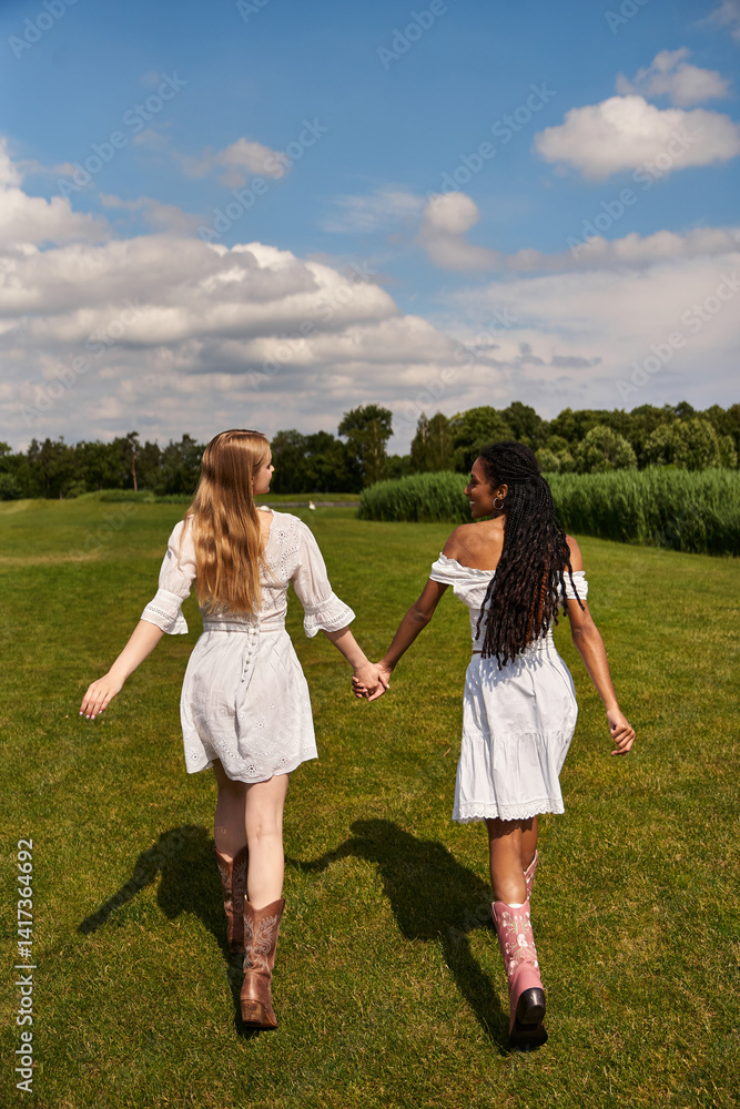 Young couple in love explores a beautiful green field on a sunny day together Young couple in love explores a beautiful green field on a sunny day together