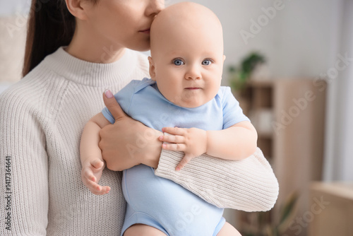 Mother hugging her little b...