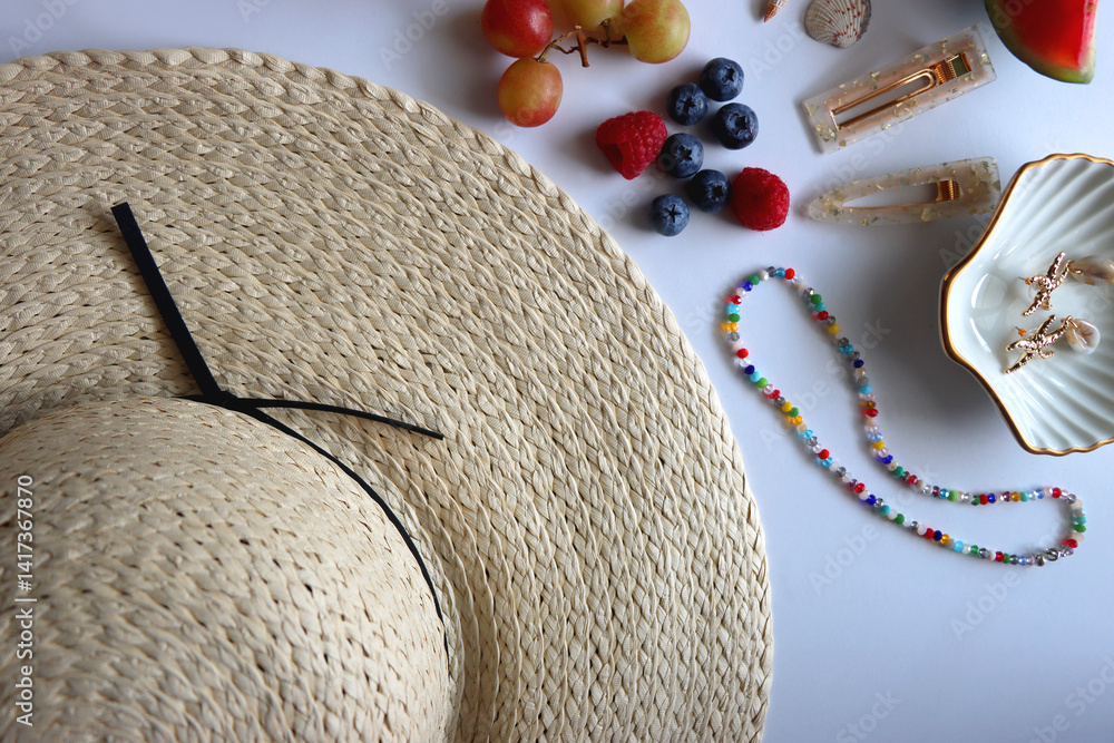 Straw hat, sunglasses, seasonal fruit, seashells and colorful accessories on white backgrounds. Cute summer essentials. Flat lay.
