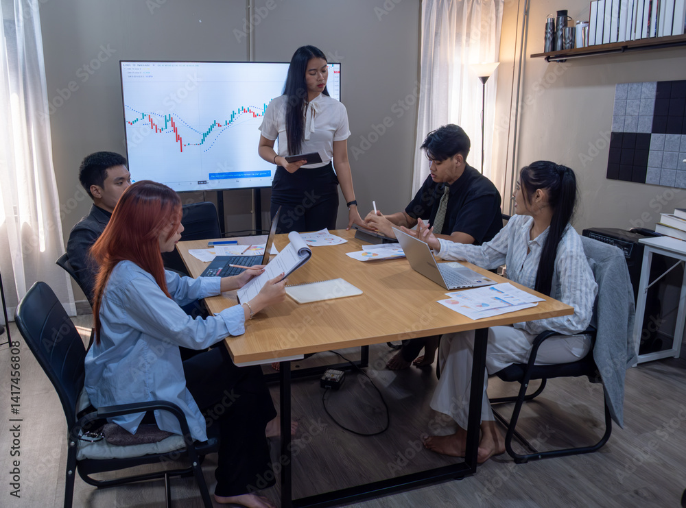 Business meeting with a presentation on financial data in a modern office setting Business meeting with a presentation on financial data in a modern office setting