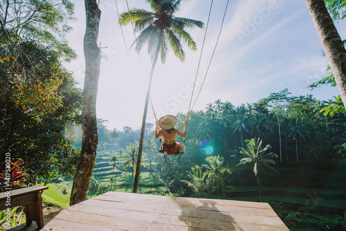 Wallpaper Mural Beautiful girl visiting the Bali rice fields in tegalalang, ubud. Using a swing over the jungle. Concept about people, wanderlust traveling and tourism lifestyle Torontodigital.ca