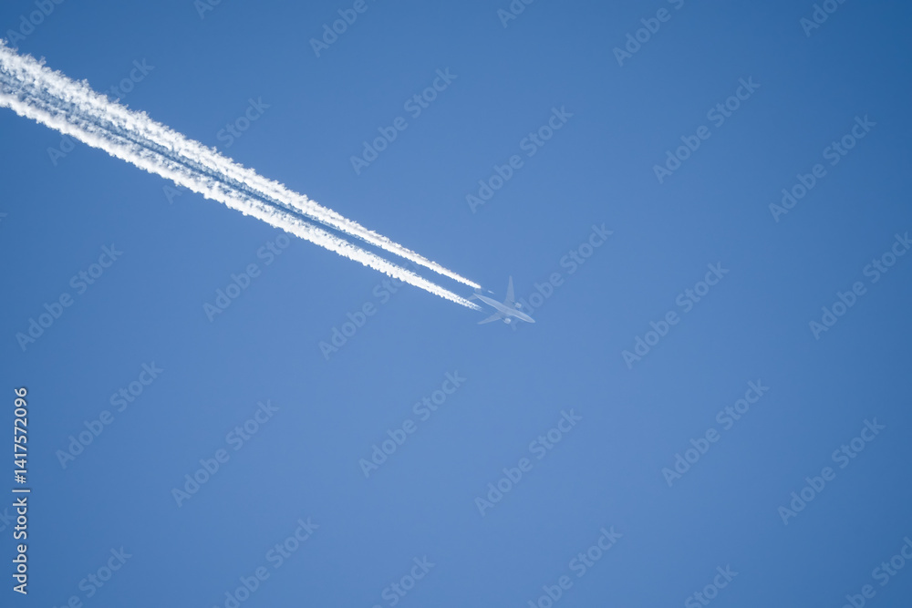 jet liner aircraft in deep blue sky, contrails vapour trails jet liner aircraft in deep blue sky, contrails vapour trails