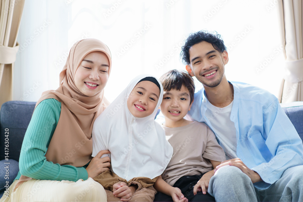 Happy Asian muslim family's portrait in living room. Happy Asian muslim family's portrait in living room.