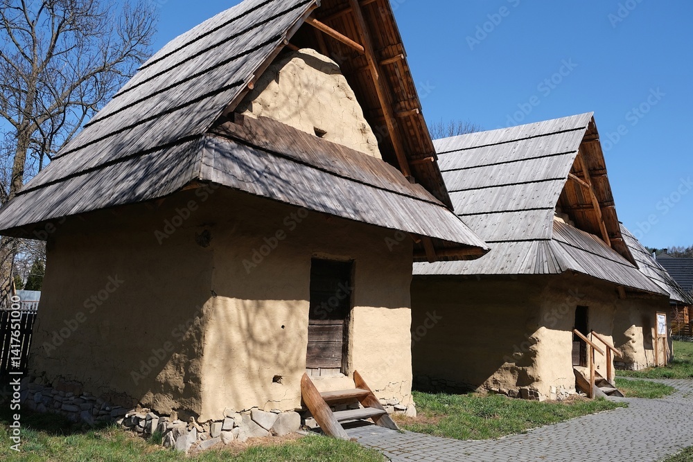 Hiscoric buildings named sypaniec in Kacwin, Poland. These are original Spis granaries - wooden grain warehouses, stone foundation covered with clay with movable sloping roof.