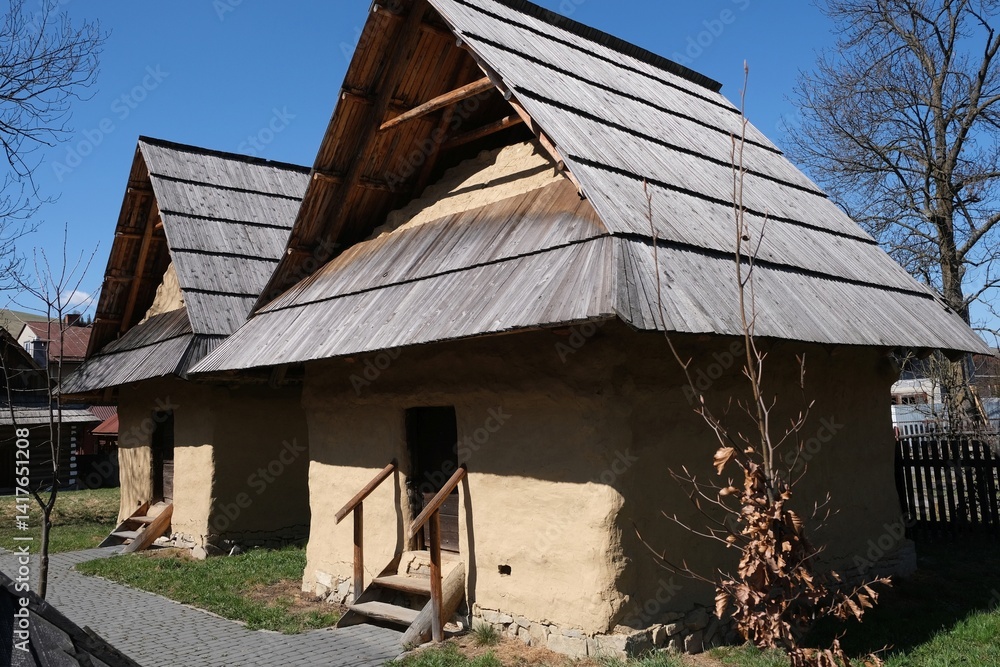 Hiscoric buildings named sypaniec in Kacwin, Poland. These are original Spis granaries - wooden grain warehouses, stone foundation covered with clay with movable sloping roof.