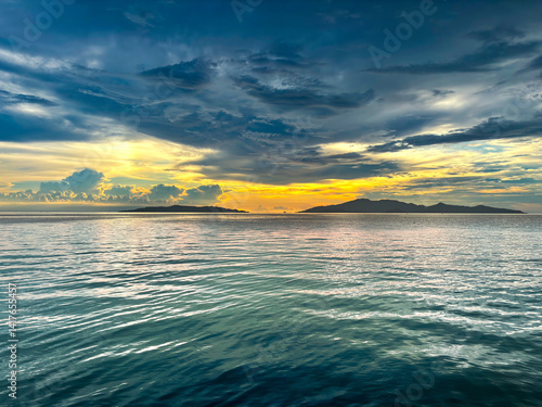 Photography sunset view at dusk between Maniang Island and Padamarang Island
