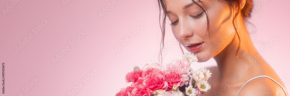 Young Caucasian woman in a soft beauty pose holding a bouquet of pink carnations and daisies. Feminine floral concept ideal for skincare, fragrance, or lifestyle advertisement. Young Caucasian woman in a soft beauty pose holding a bouquet of pink carnations and daisies. Feminine floral concept ideal for skincare, fragrance, or lifestyle advertisement.