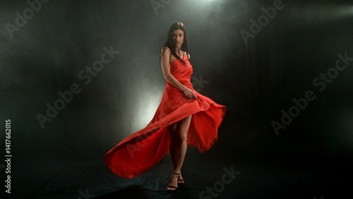 Woman in red dress dancing with flying fabric, Fashion Model Girl Posing with waving cloth