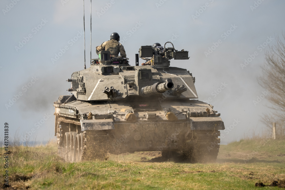close-up of a commander directing a Challenger 2 II FV4034 main battle tank, reversing away at high speed