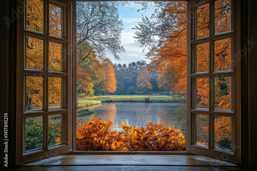 Window with view of lake and trees reflecting in water. Bright sunlight streaming through creating a serene and picturesque scene.