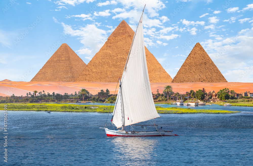 Beautiful Nile scenery with traditional Felluca sailing boat in the Nile on the way to Giza pyramids - Cairo, Egypt