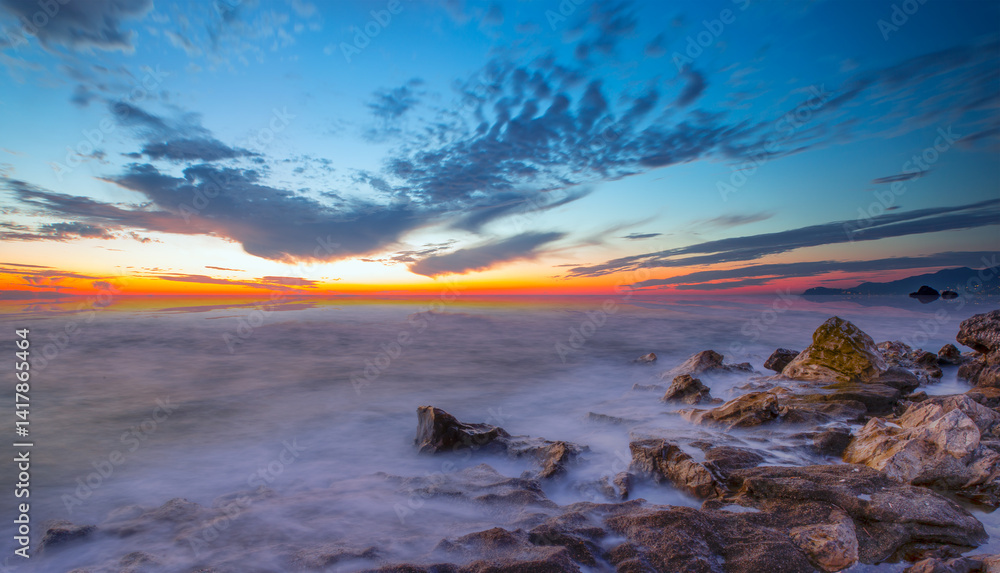 Long exposure photo of sunset on a rocky beach - Alanya, Turkey