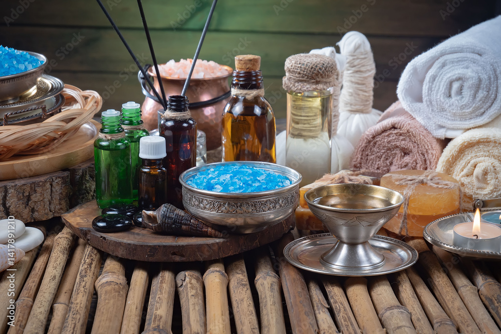 Spa treatment with candles and towel on wooden table, closeup