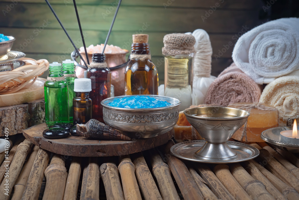 Spa treatment with candles and towel on wooden table, closeup