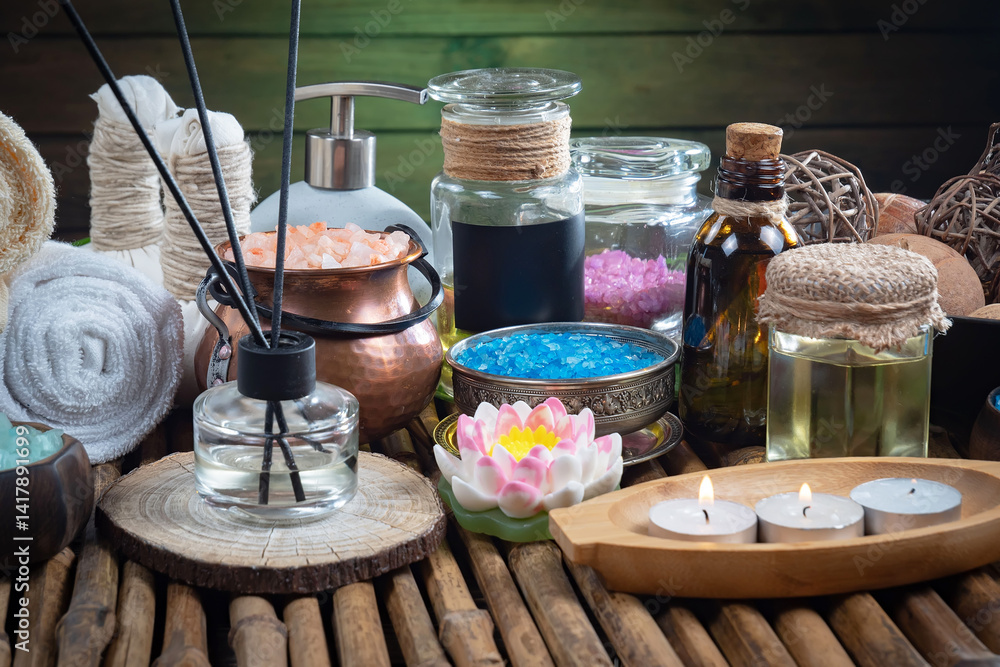 Spa treatment with candles and towel on wooden table, closeup