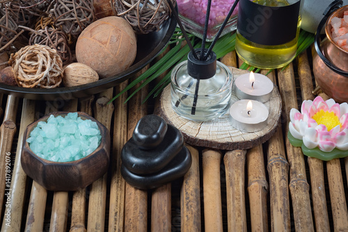 Spa treatment with candles and towel on wooden table, closeup