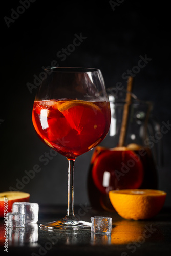 Obraz na płótnie Refreshing red wine sangria or punch with fresh fruits in glasses and pincher on black background w salonie