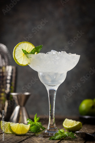 Obraz na płótnie Cocktail margarita garnished with lime and mint on wooden background w salonie