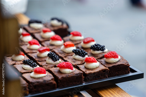 Obraz na płótnie Catering service offering small brownies decorated with cream and berries w salonie