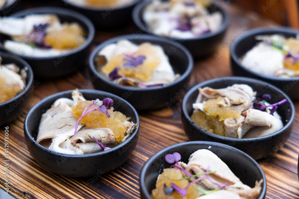 Catering company preparing delicious canapes with meat, sauce and microgreens