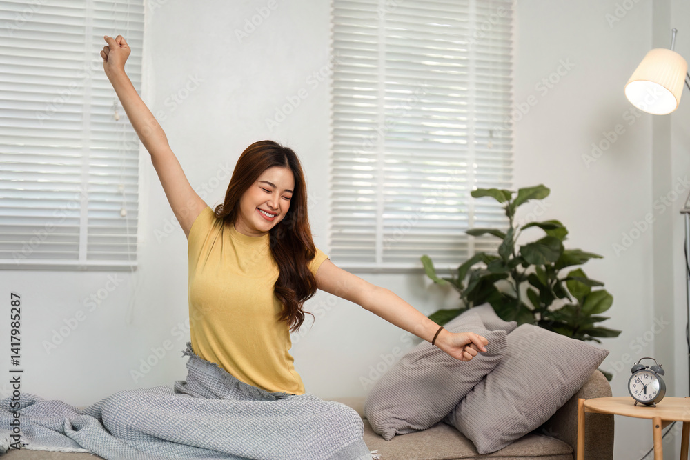 Morning Stretch and Happiness. A young woman happily stretching in bed, welcoming the day with an infectious smile and positive energy. Morning Stretch and Happiness. A young woman happily stretching in bed, welcoming the day with an infectious smile and positive energy.