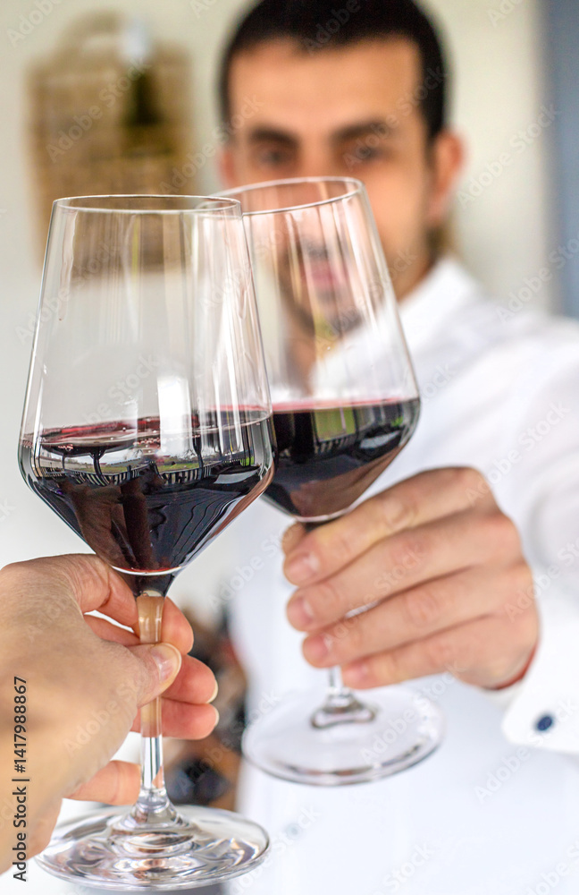 Glass of red wine in hands. Selective focus. Glass of red wine in hands. Selective focus.