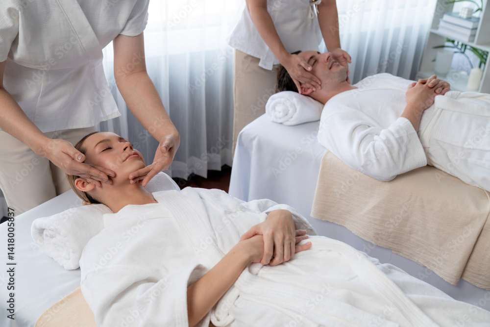 Fototapeta premium Caucasian couple enjoying relaxing anti-stress head massage and pampering facial beauty skin recreation leisure in dayspa modern light ambient at luxury resort or hotel spa salon. Quiescent