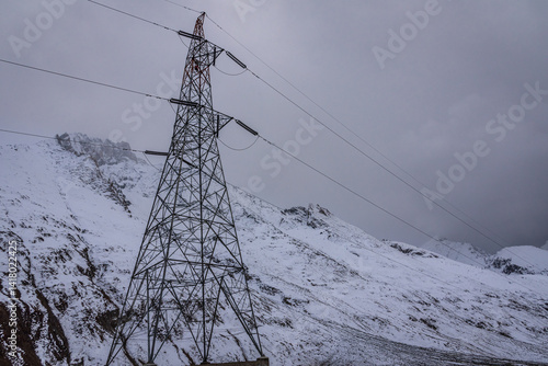 Transmission tower or pylon a steel lattice tower support overhead power line. Electricity transmission in mountainous regions through complicated geographic conditions in Leh Ladakh, India.