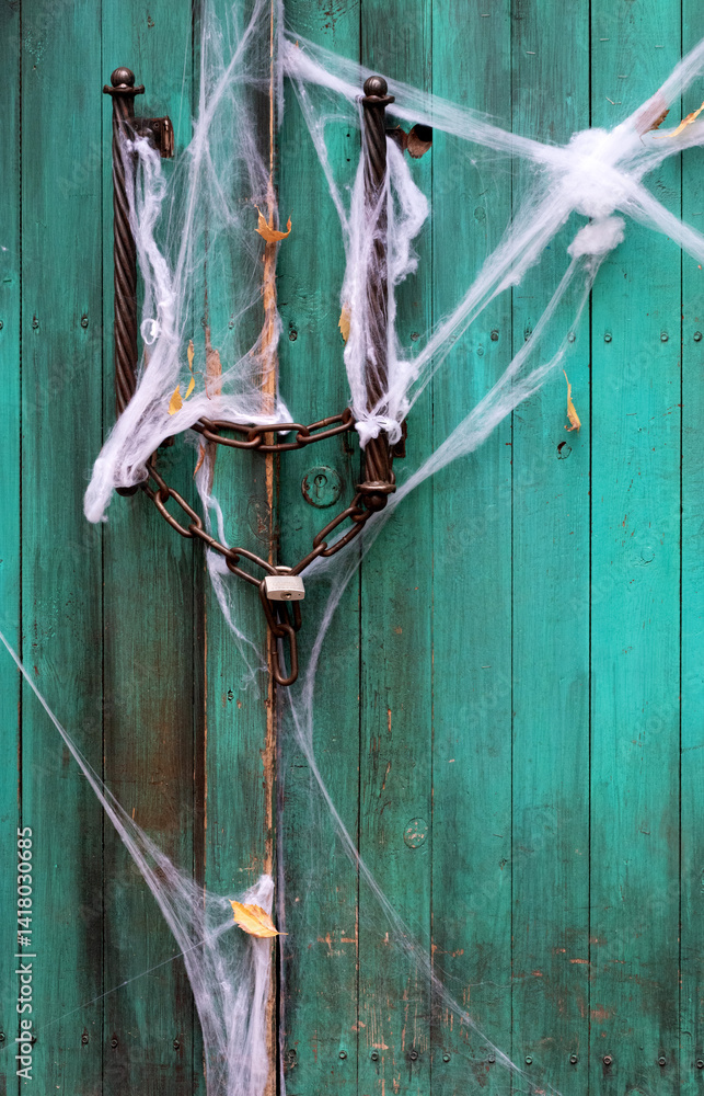 Spooky wooden door with cobwebs – Halloween decoration with eerie autumn atmosphere, haunted house entrance, dark rustic scene, horror themed photo
