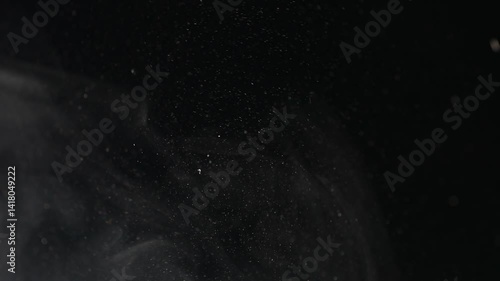 Particles drops on black background