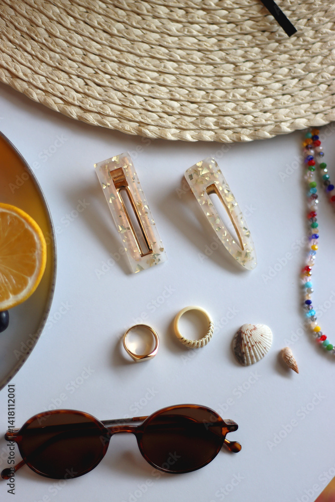 Glass of cocktail, straw hat, sunglasses, books, fresh fruit, chocolate and accessories. Summer essentials on the table. Top view.