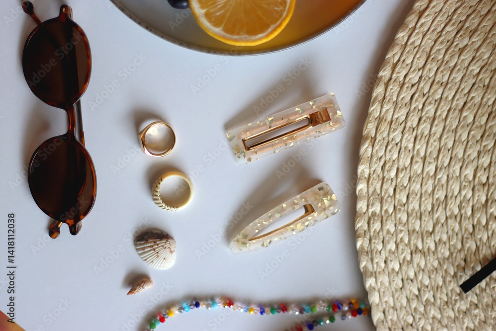 Glass of cocktail, straw hat, sunglasses, books, fresh fruit, chocolate and accessories. Summer essentials on the table. Top view.